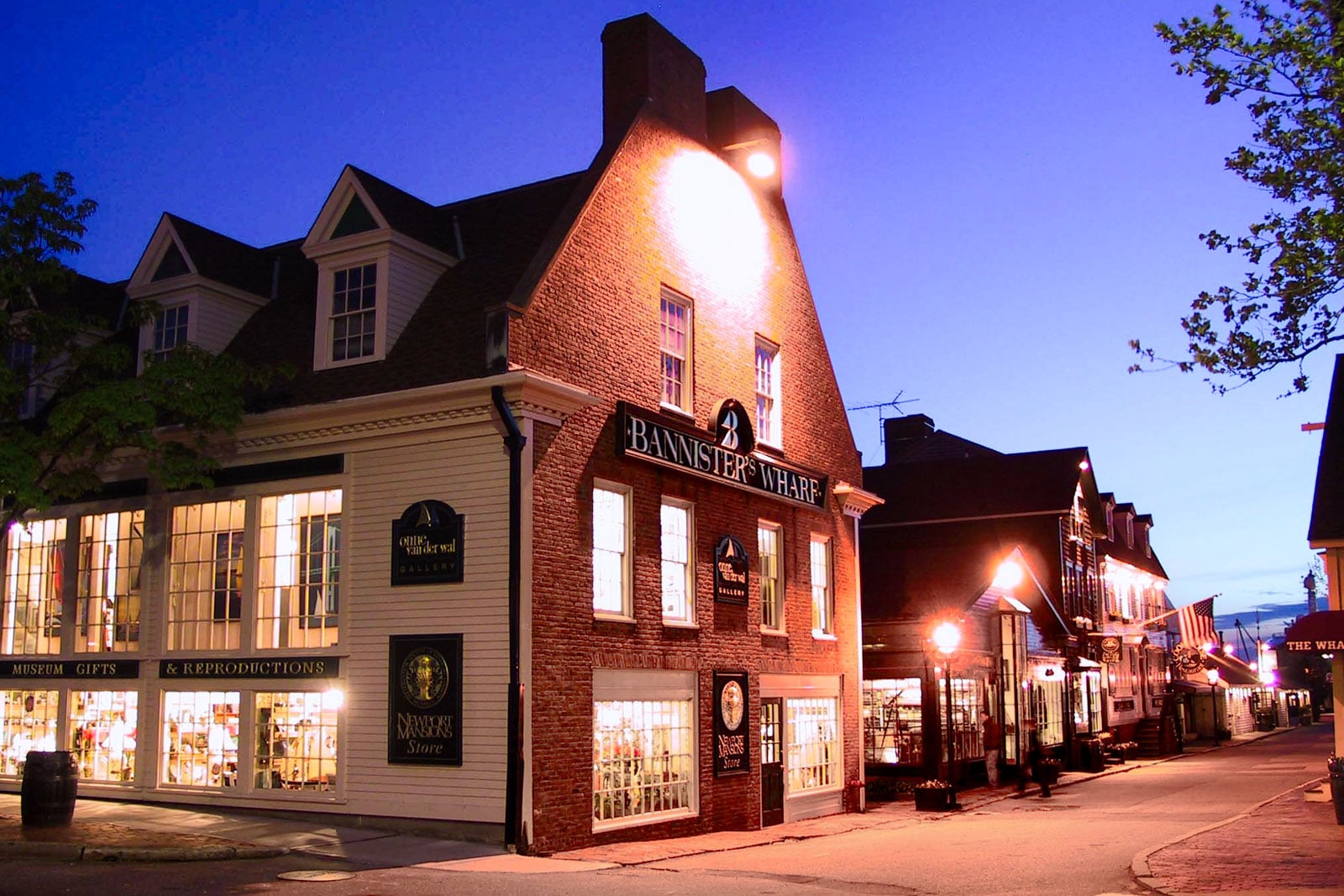 A main street lane with several shops at dusk.