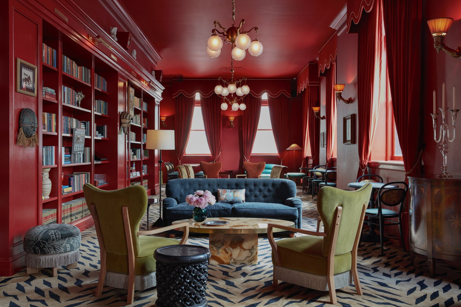 An eclectically decorated sitting room features sofas and chairs.