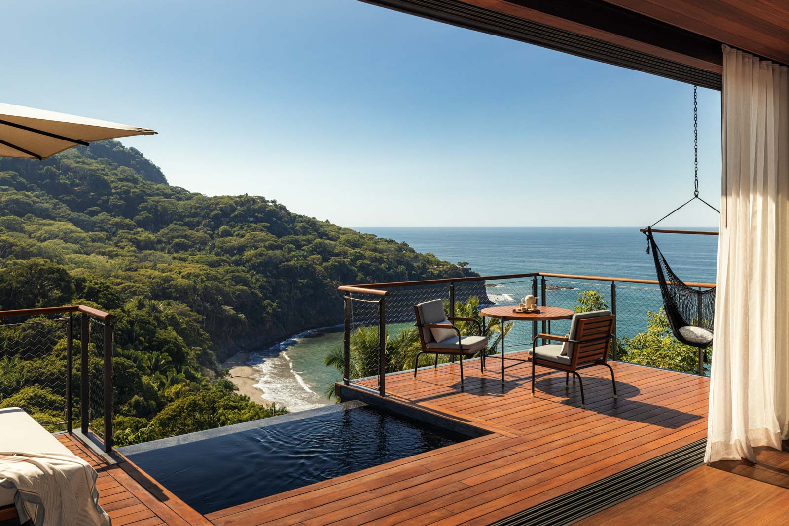 Balcony with chairs overlooking ocean