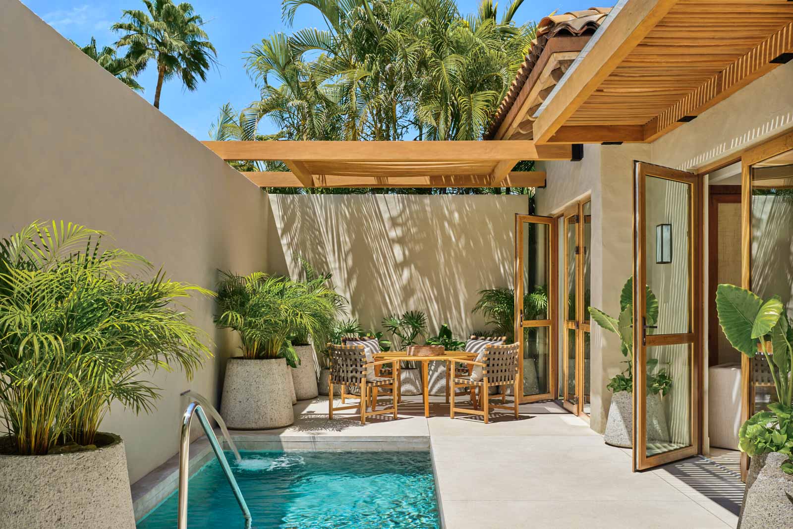 Lounge chairs line a private pool