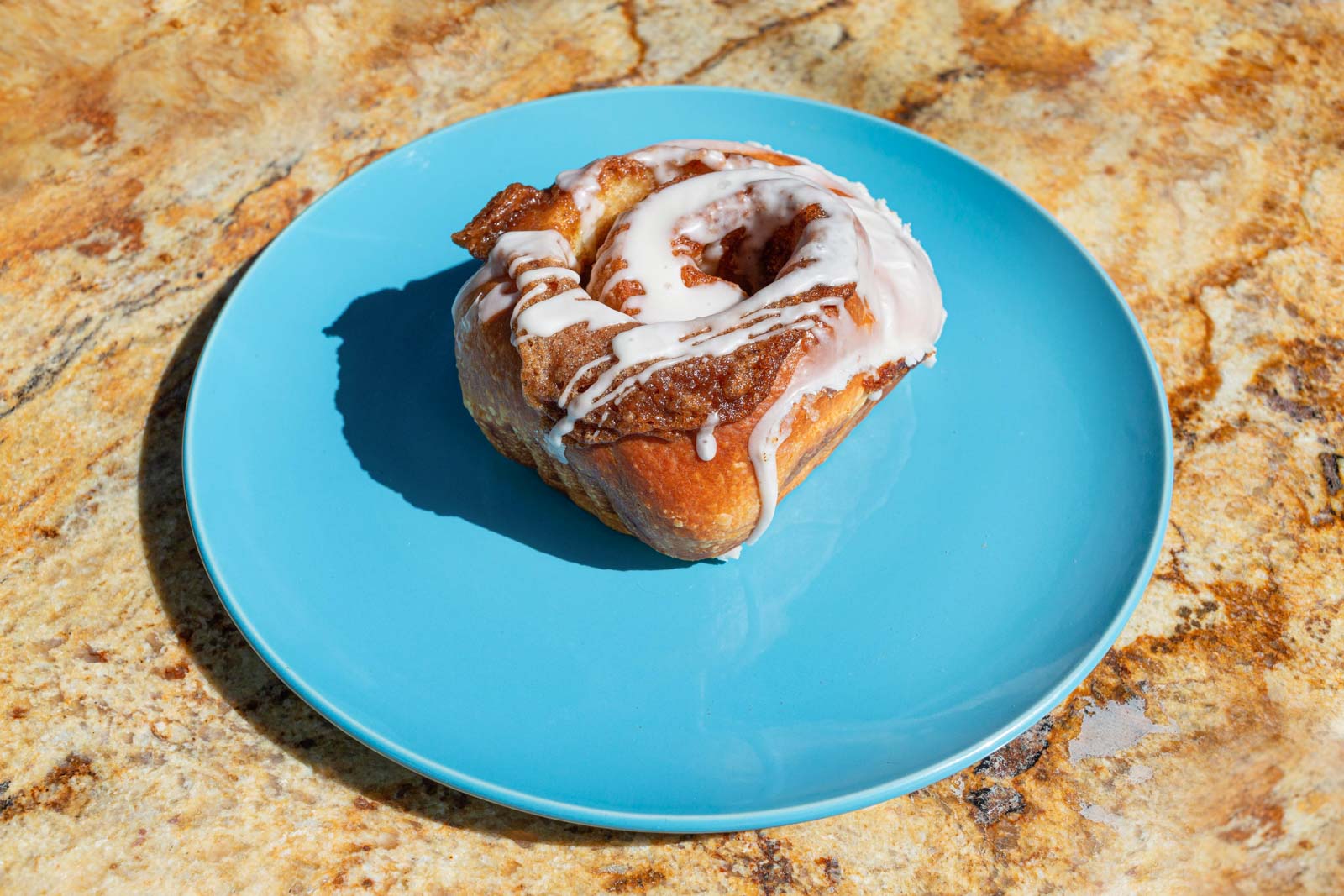 Iced cinnamon roll on a plate